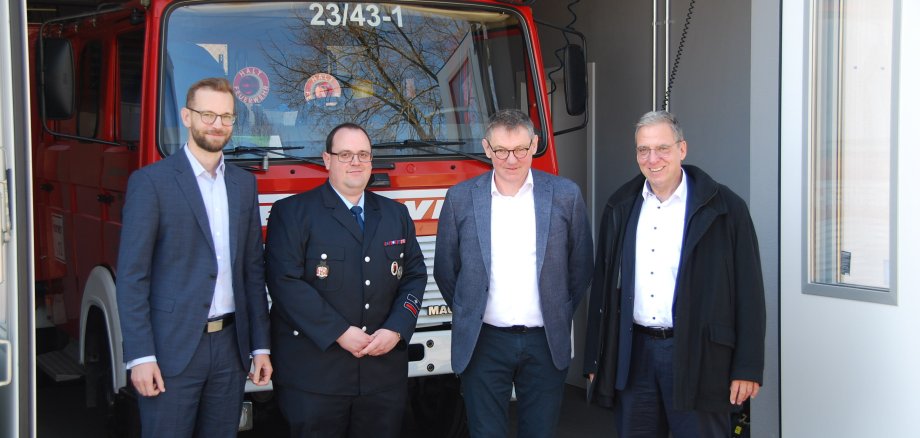 Ulrich Richter-Hopprich, Wehrführer Daniel Herborn, Ortsbürgermeister Martin Bendel und Andree Stein, der Erste Beigeordnete der VG Montabaur, vor dme neuen Feuerwehgerätehaus.