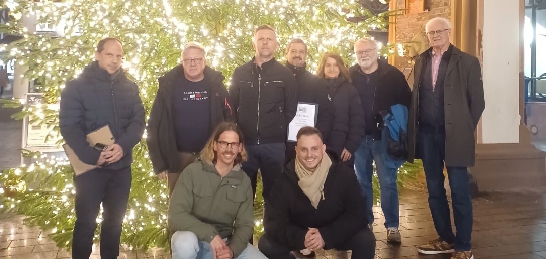 Die Wärme- und Klimabotschafter treffen sich mit Vertretern der VG zu einem Gruppenfoto vor dem großen Weihnachtsbaum vor dem alten Rathaus.