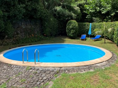 Ein runter Pool in einem Garten.