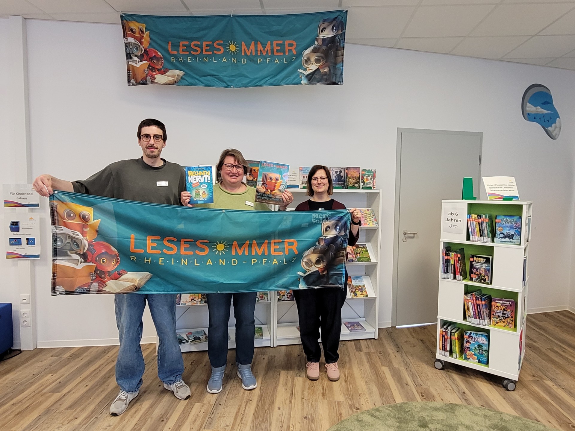 Das Team der Stadtbibliothek (v.l.) Lukas Wilhelmi, Susanne Walter-Hahn, Carina Senko freut sich darauf, viele Kinder im eigens für den LESESOMMER angelegten Kinderbe-reich zu begrüßen.